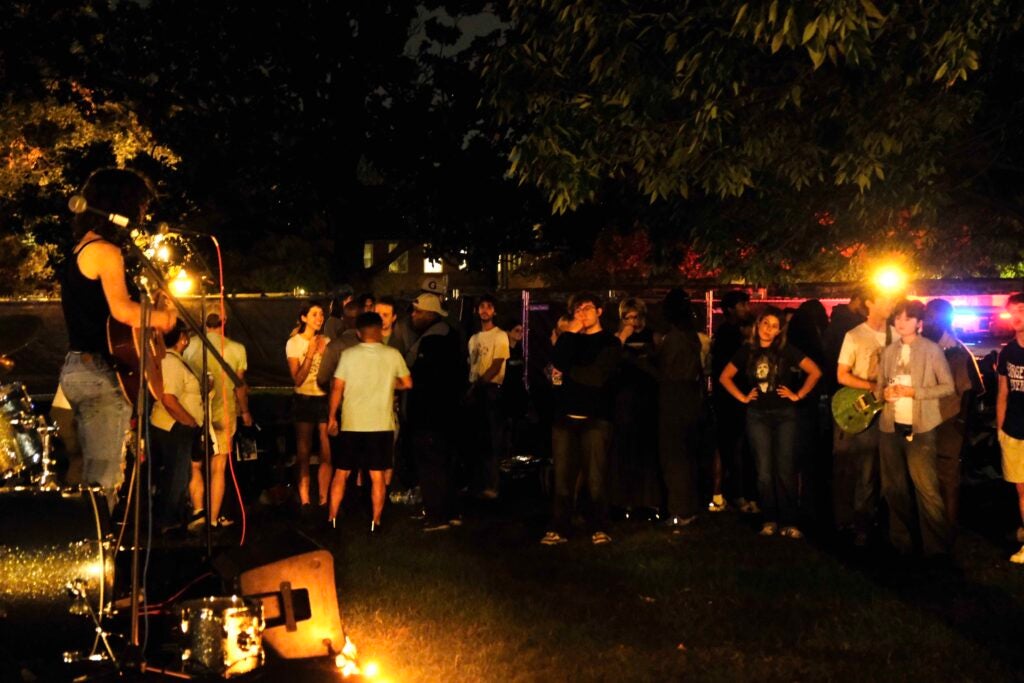 Photo of Georgetown front lawn with students gathered in front of a stage.