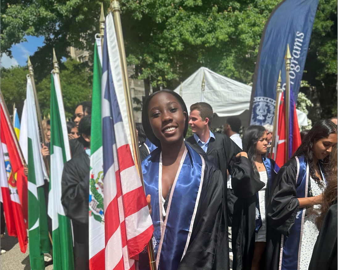 Caption: Divinna proudly carrying Liberia's flag during the 2025 Senior Convocation, hopeful that one day she will return home and help create lasting change.