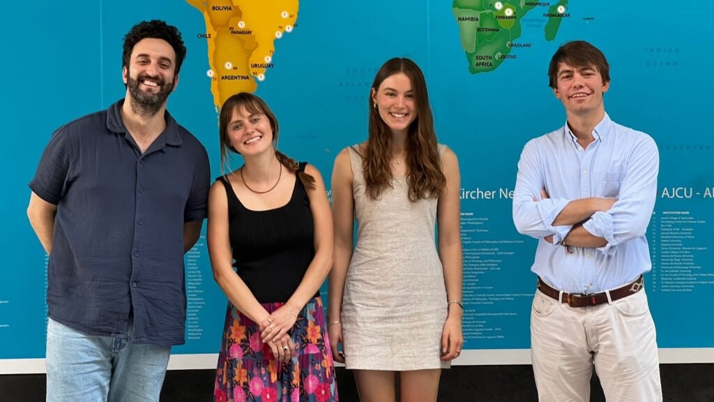 Students standing in front of a map at Loyola University campus in Seville (Source: Stella Vance's personal photos).